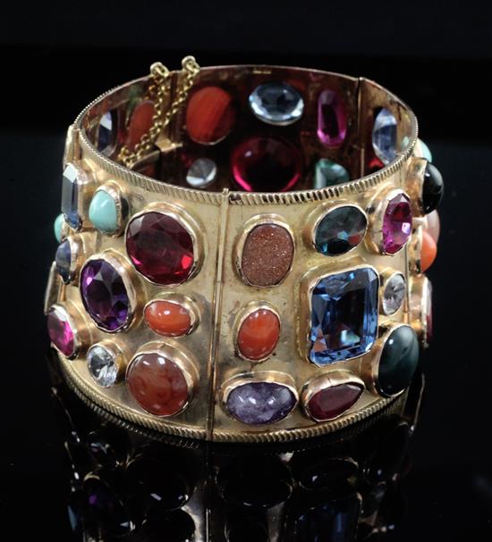 A 20th century Middle Eastern gold and multi gem set tapering articulated bracelet,